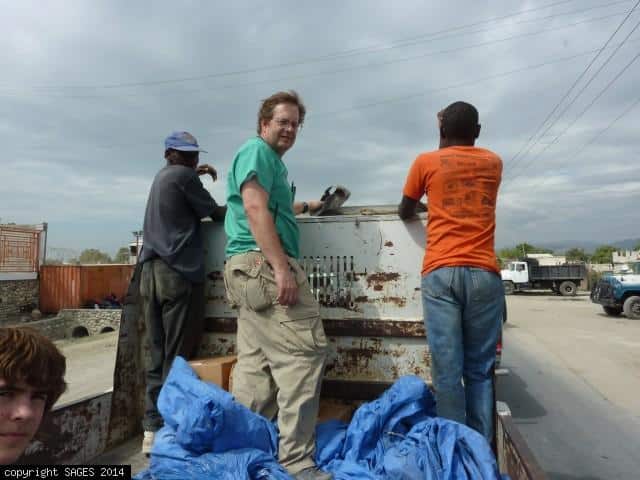 Riding in truck distributing supplies Haiti
